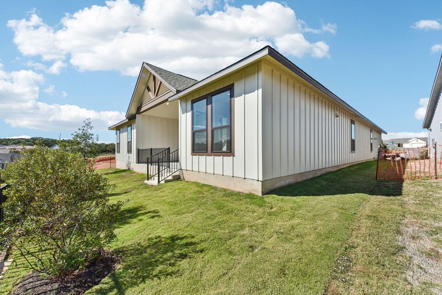 View of property exterior featuring board and batten siding and roof with shingles