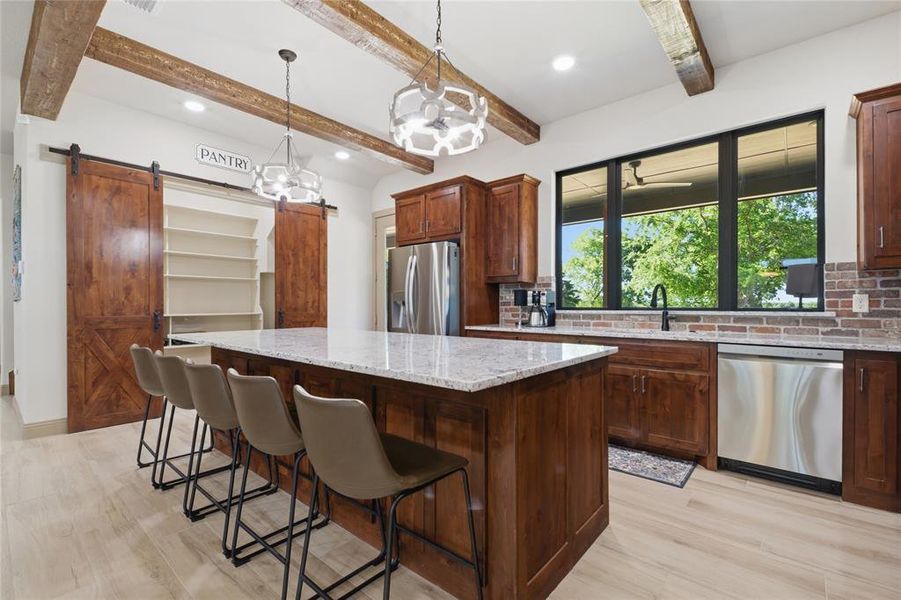 Kitchen island featuring a light-toned countertop and wood-finish cabinetry