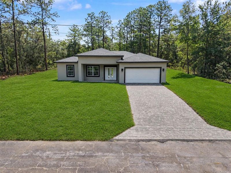 Front exterior of a new home in , Citrus Springs, FL, highlighting curb appeal (Image 23).