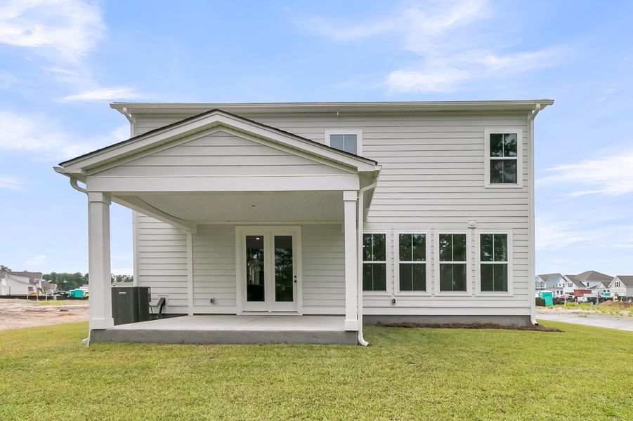 Exterior details and patio area of a home in Tidewater at Lakes of Cane Bay, Summerville (Image 26).