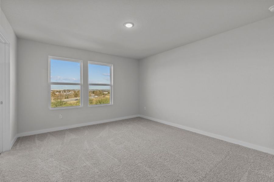 A room with a window and a carpet.