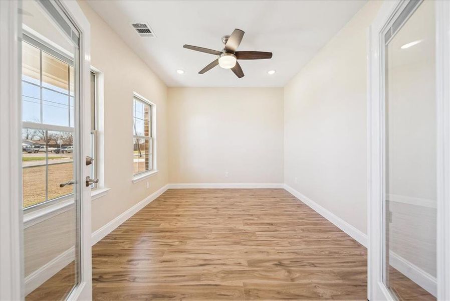 Unfurnished room featuring ceiling fan and light wood-type flooring