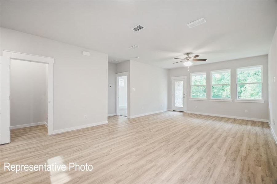 Unfurnished room with ceiling fan and light hardwood / wood-style floors