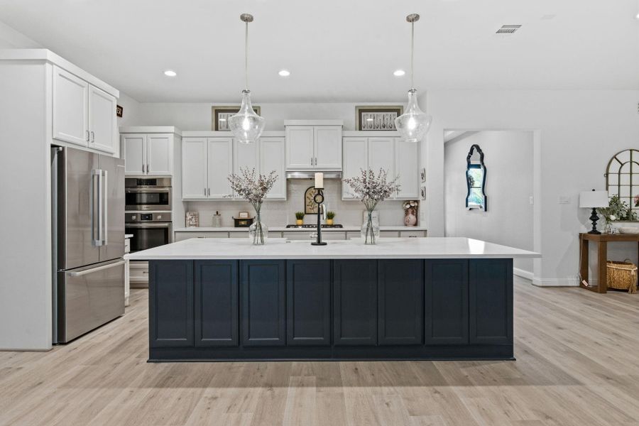 This large island will fit several counter height bar stools for quick meals and conversation.