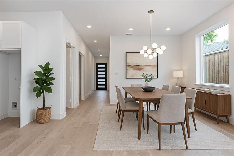 Dining area with light wood-style flooring, recessed lighting, a chandelier, and baseboards