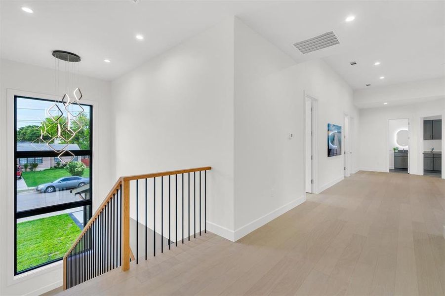 Hallway featuring recessed lighting, light wood-type flooring, and an upstairs landing