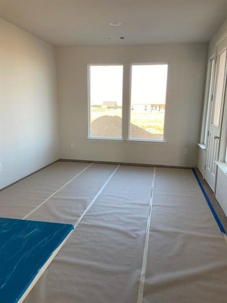 Spacious room featuring multiple windows, recessed lighting, and a white paneled door