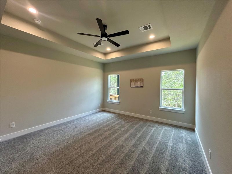 Primary bedroom with view of the backyard. Primary bedroom with view of the backyard.