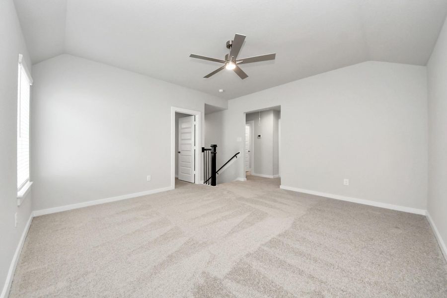 Ascend to relaxation in this fantastic game room! Ideal for both casual gatherings and adult gaming, it boasts plush carpet, lofty ceilings, custom paint, and ample windows for abundant natural light.