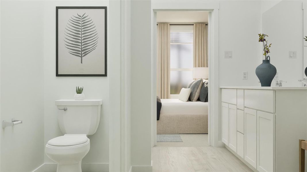 Ensuite bathroom featuring toilet and light wood-style floors Ensuite bathroom featuring toilet and light wood-style floors