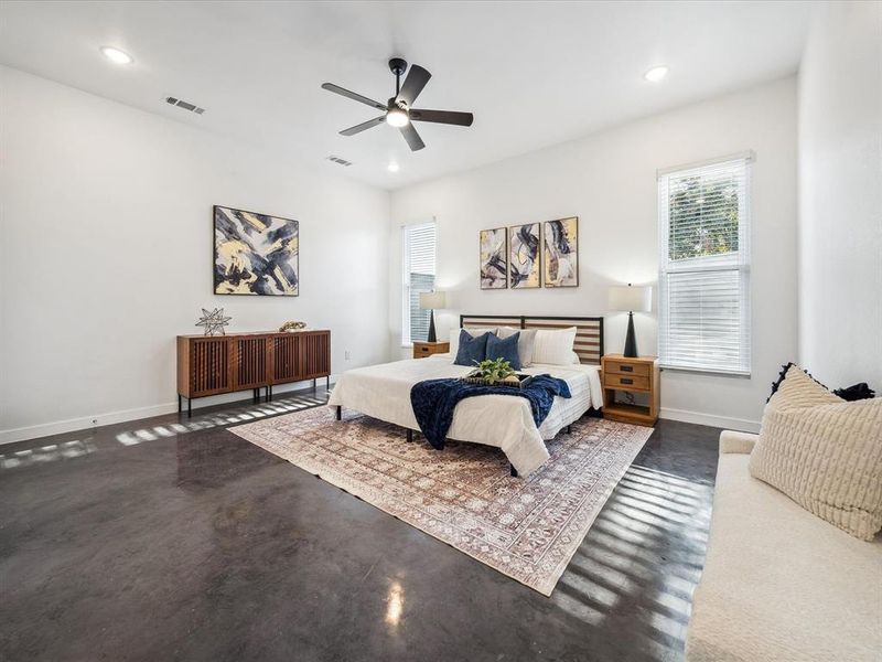 Bedroom with ceiling fan and concrete flooring