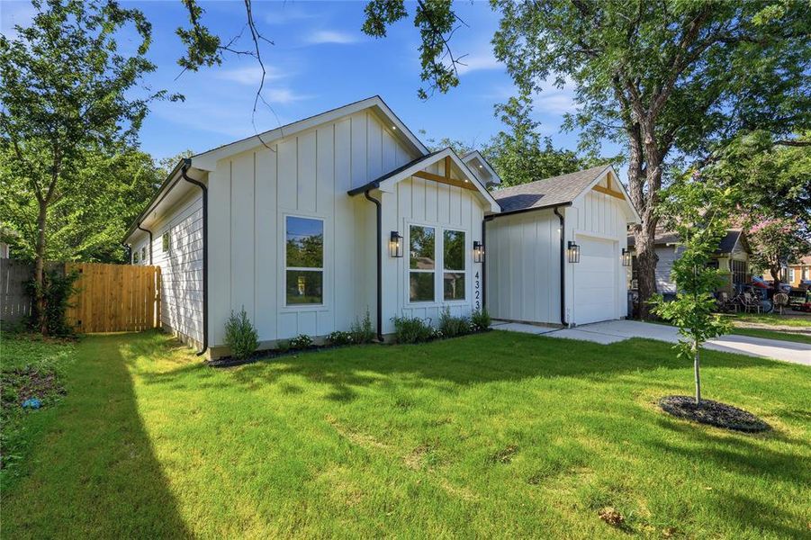 White board and batten exterior with dark trim accents White board and batten exterior with dark trim accents