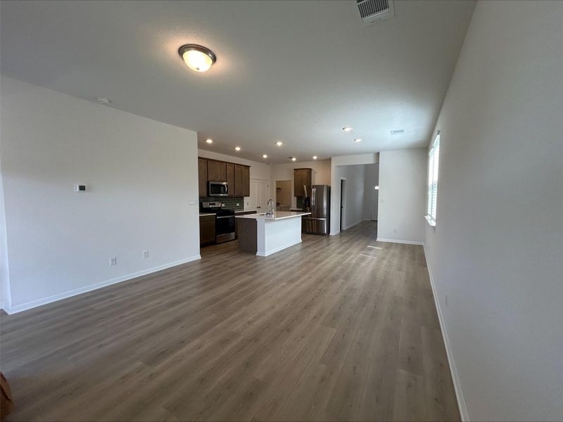 Unfurnished living room with wood finished floors and recessed lighting Unfurnished living room with wood finished floors and recessed lighting