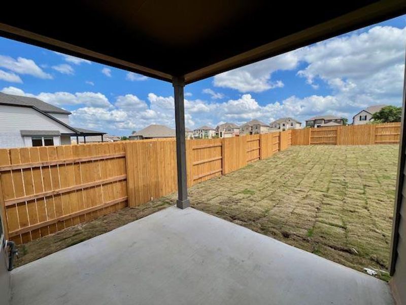 Fenced backyard with a patio and a residential view Fenced backyard with a patio and a residential view