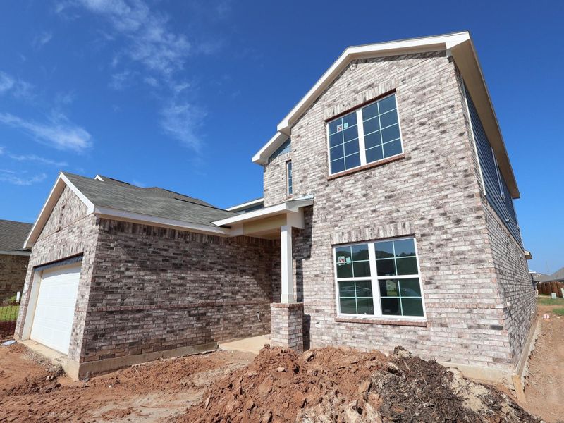 Front exterior of a new home in Magnolia Ridge, Magnolia, TX, highlighting curb appeal (Image 1). Front exterior of a new home in Magnolia Ridge, Magnolia, TX, highlighting curb appeal (Image 1).