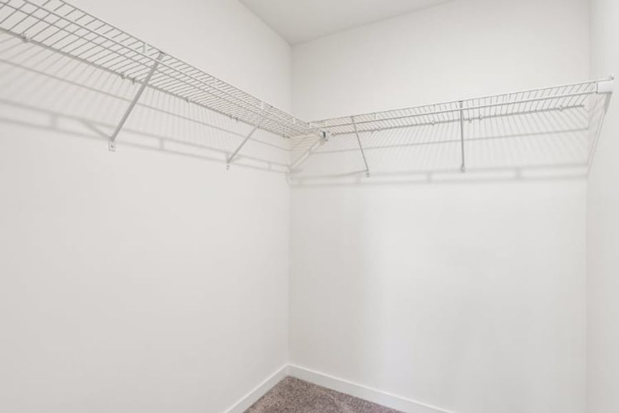 A white wall with a metal bar.