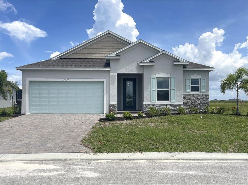 Front exterior of a new home in Heritage Station, Punta Gorda, FL, highlighting curb appeal (Image 1). Front exterior of a new home in Heritage Station, Punta Gorda, FL, highlighting curb appeal (Image 1).