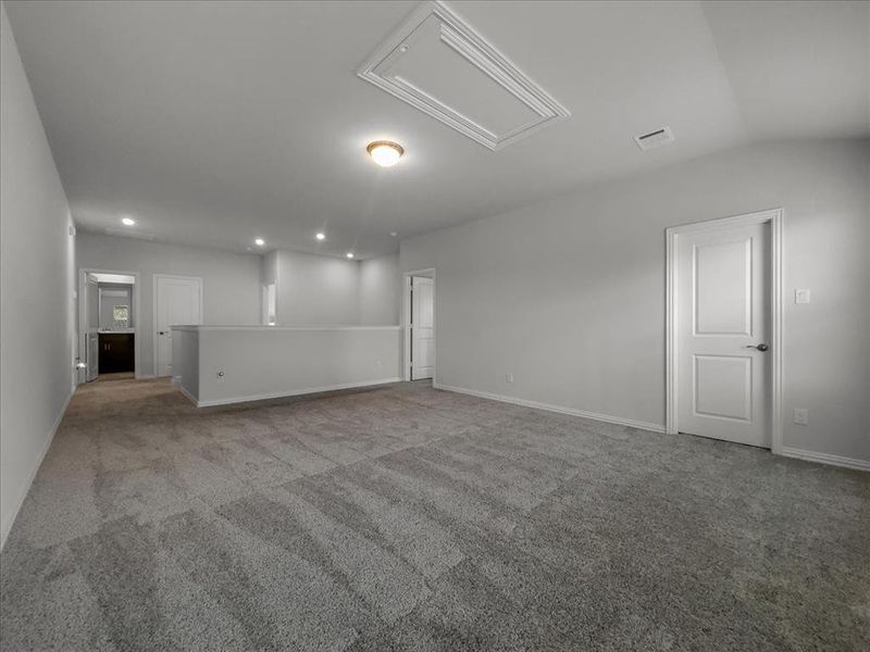 Unfurnished living room featuring light carpet and vaulted ceiling