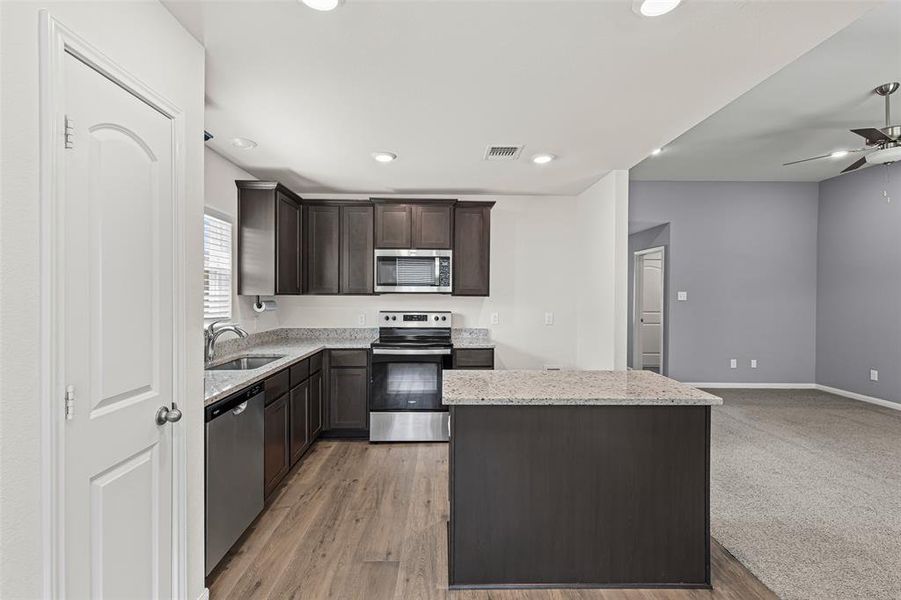 Kitchen with granite counters, island and so many cabinets Kitchen with granite counters, island and so many cabinets