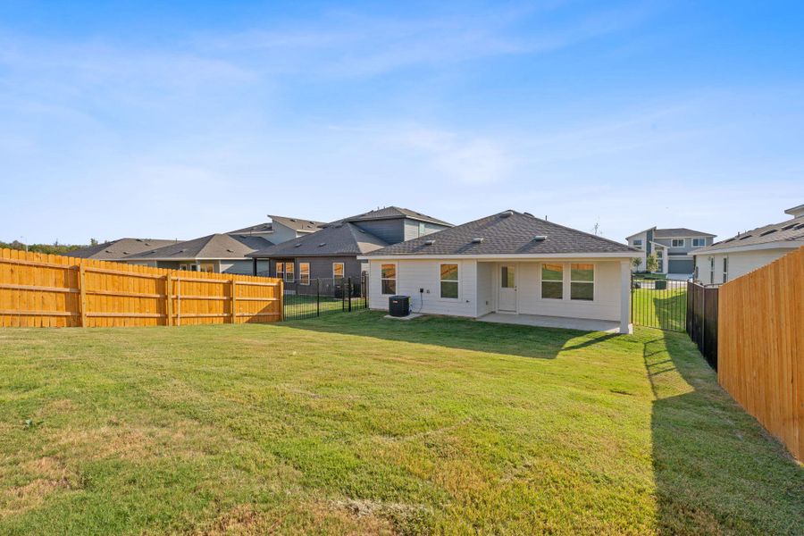 Rear view of property featuring a patio area and a fenced backyard