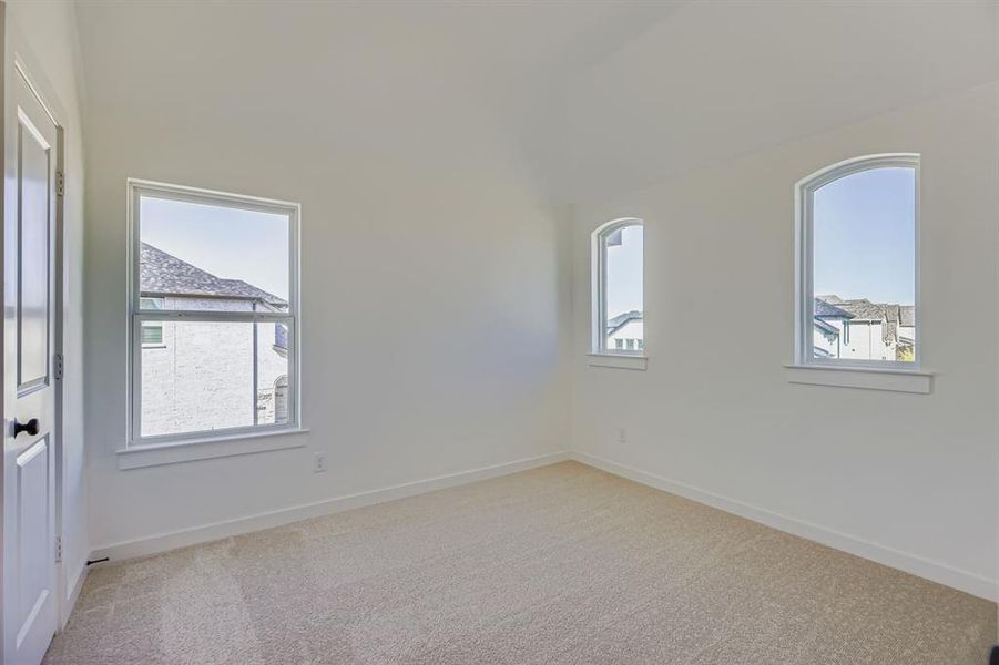Empty room with light colored carpet and baseboards Empty room with light colored carpet and baseboards
