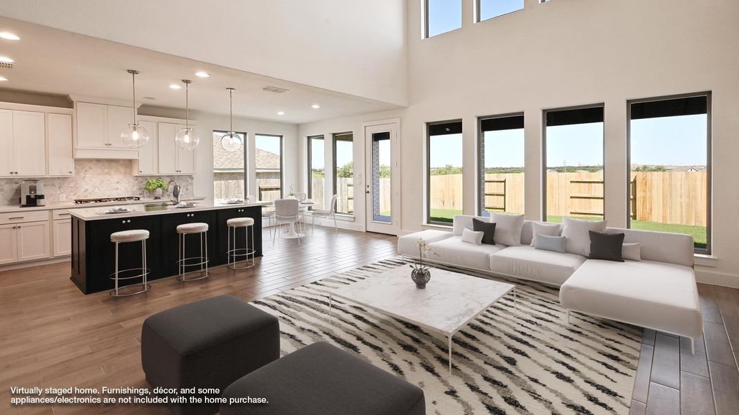 Living area featuring recessed lighting, dark wood-type flooring, and a high ceiling