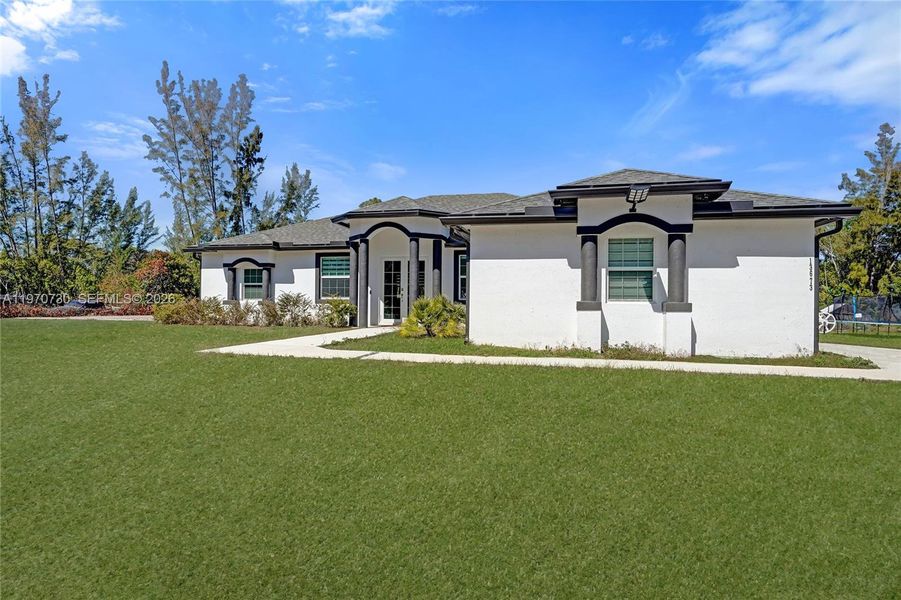 Front exterior of a new home in , Loxahatchee, FL, highlighting curb appeal (Image 30).