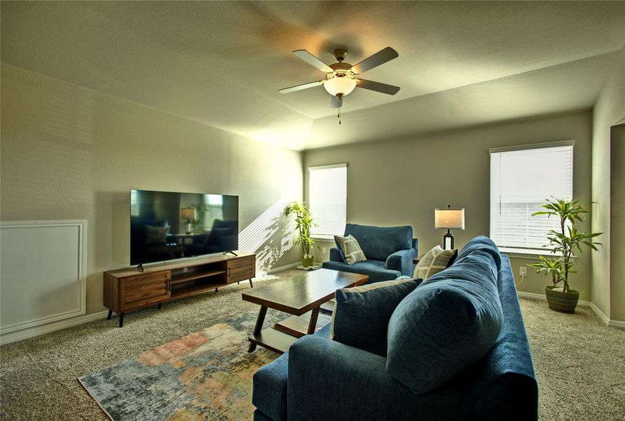 Carpeted game room featuring ceiling fan and baseboards Carpeted game room featuring ceiling fan and baseboards