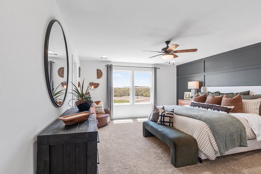 A bedroom with a large mirror.