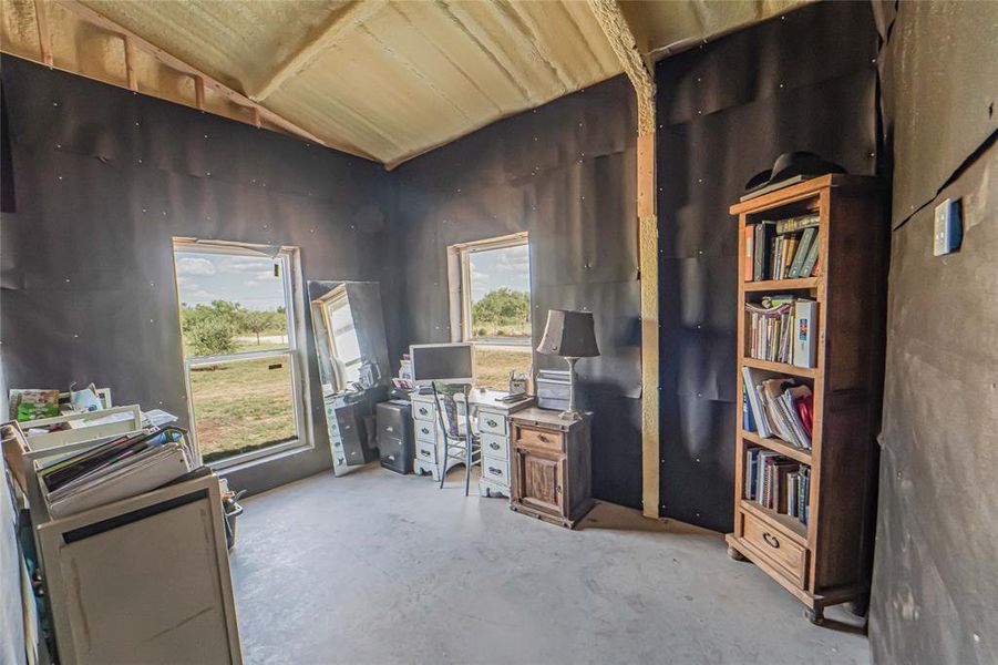 Office area with unfinished concrete floors