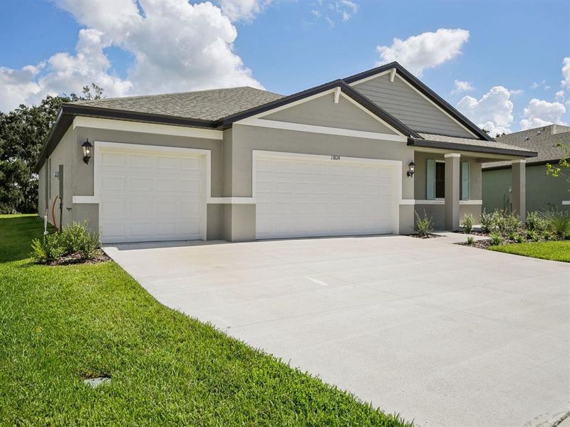 Front exterior of a new home in Salt Meadows - Signature Series, Parrish, FL, highlighting curb appeal (Image 1). Front exterior of a new home in Salt Meadows - Signature Series, Parrish, FL, highlighting curb appeal (Image 1).