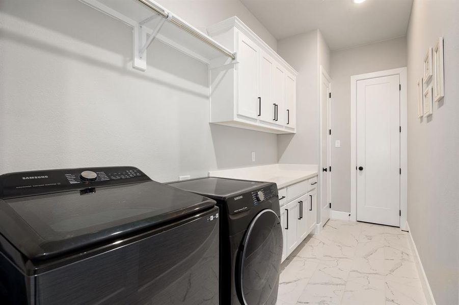 Laundry area with cabinets and independent washer and dryer