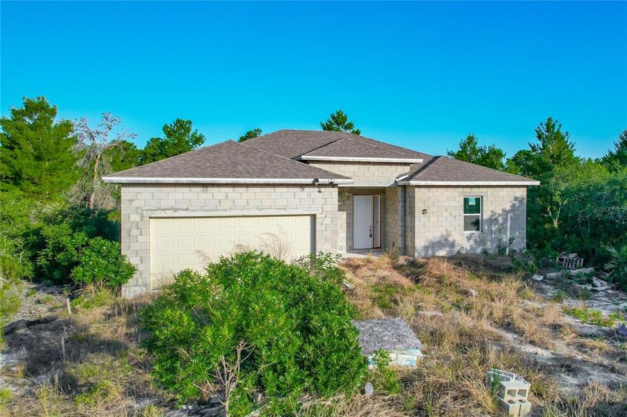 Front exterior of a new home in , Poinciana, FL, highlighting curb appeal (Image 7).