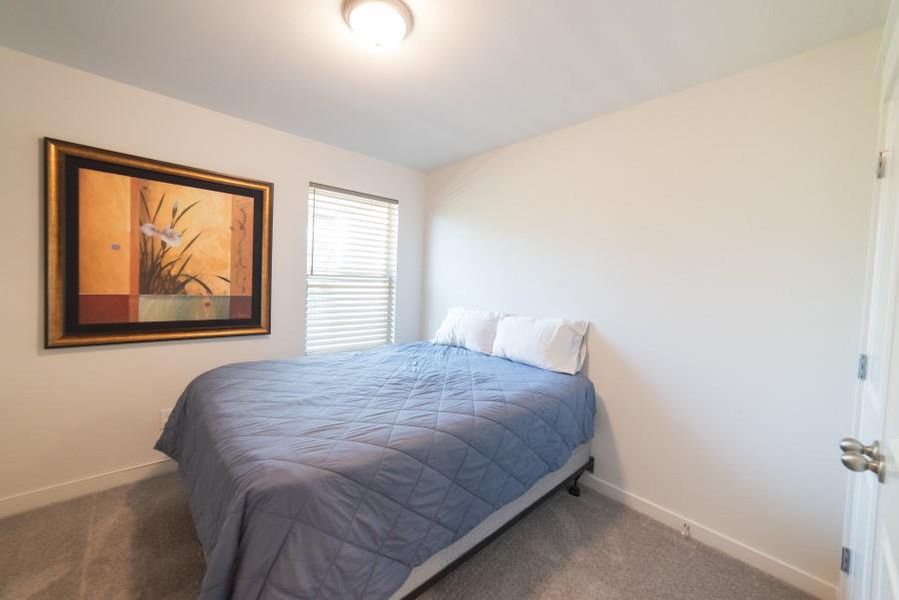 Carpeted bedroom with baseboards