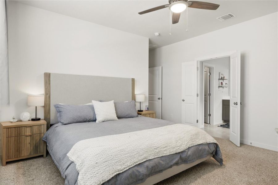 Bedroom with light colored carpet and ceiling fan