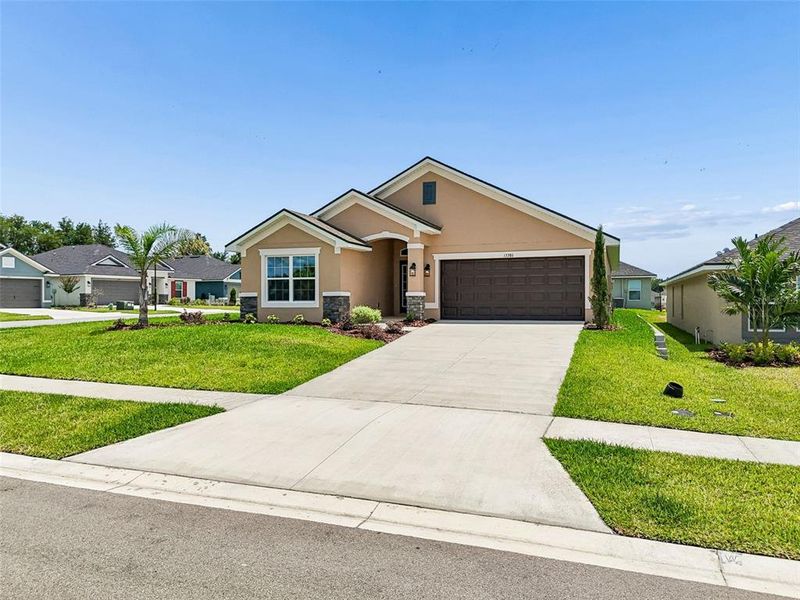 Front exterior of a new home in Abbey Glen, Dade City, FL, highlighting curb appeal (Image 33).