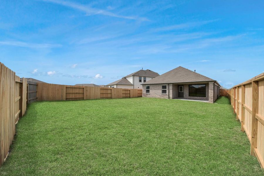 Experience outdoor living at its finest on this expansive covered patio, thoughtfully designed for BBQs and delightful outdoor dining.