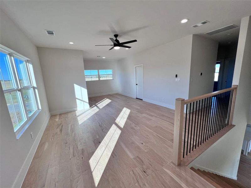 Upstairs Game Room with wood floors