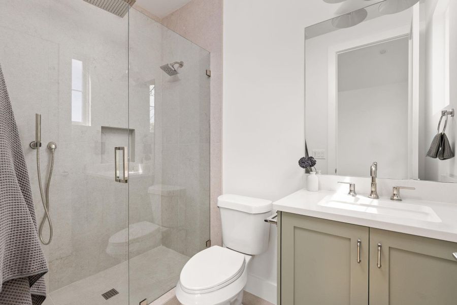 Bathroom featuring vanity and a shower stall