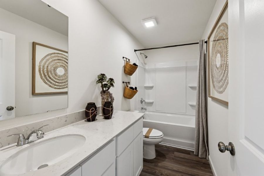 A bathroom with a sink toilet and a shower. A bathroom with a sink toilet and a shower.