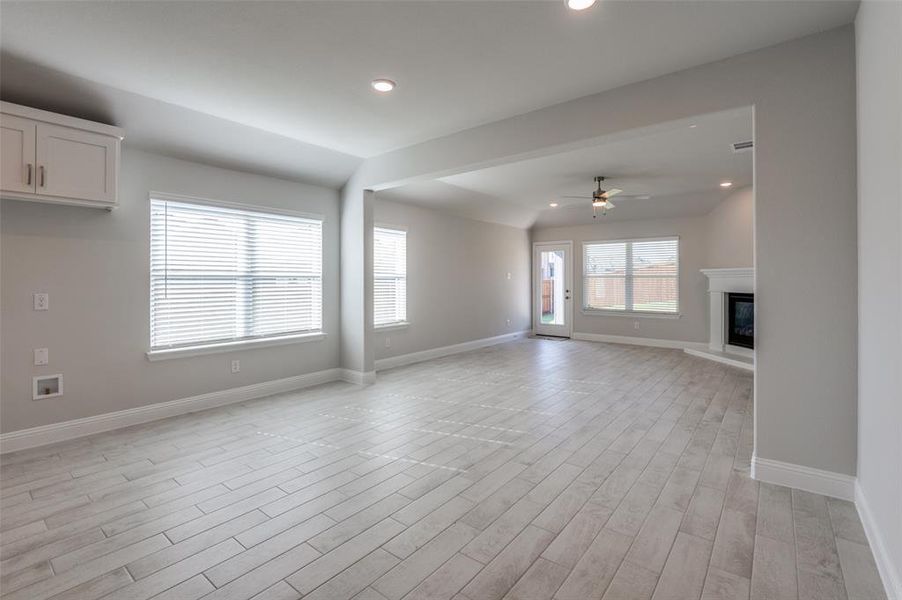 Spacious interior with plank-style flooring, recessed lighting, and light gray wall finishes