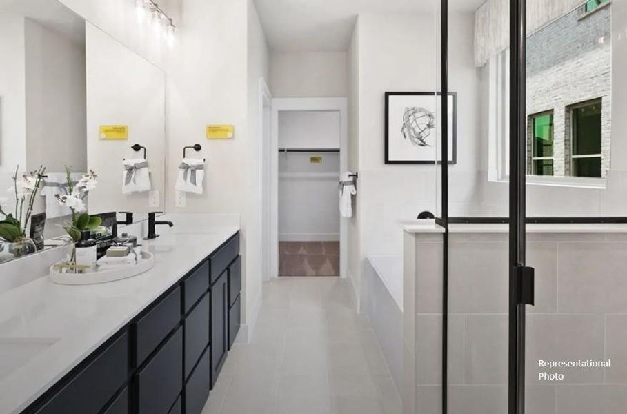 The soft glow of natural light filters through large windows, highlighting the elegant finishes – think polished countertops and luxurious tile work that catches your eye and invites you to linger.