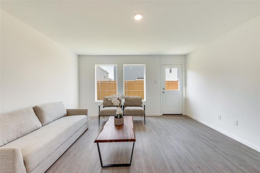 Living room with light hardwood / wood-style floors