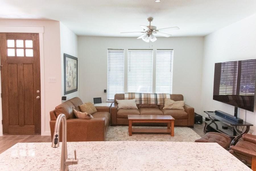 Living room featuring healthy amount of natural light and a ceiling fan