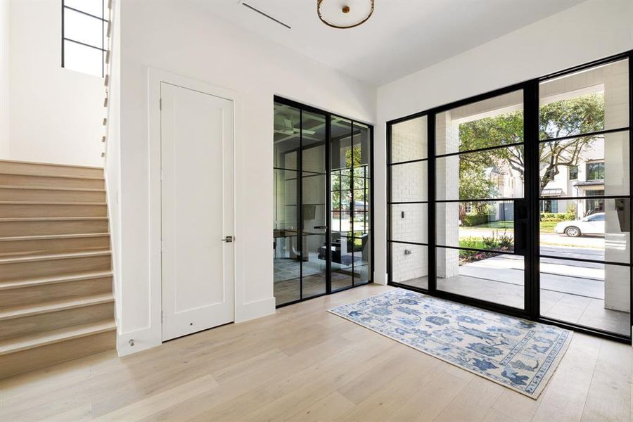 Entryway with wood finished floors, french doors, and stairs Entryway with wood finished floors, french doors, and stairs