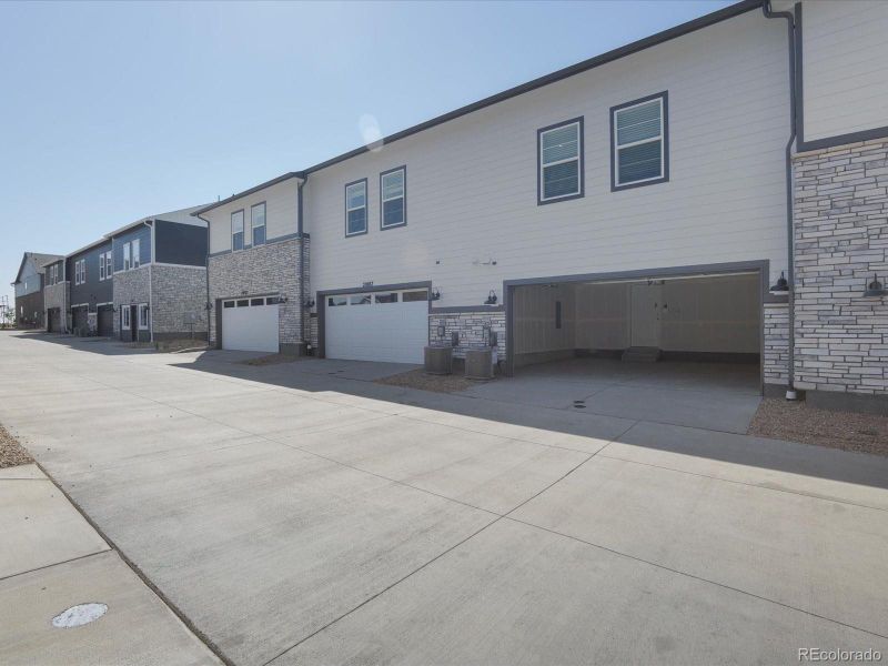 Front exterior of a new home in Skyview at High Point, Aurora, CO, highlighting curb appeal (Image 22).
