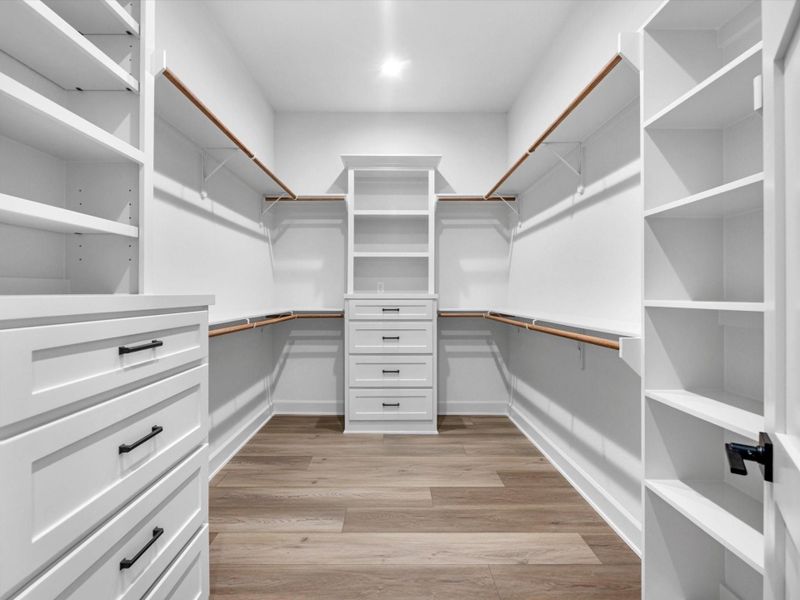 Expansive walk-in closet with built-ins, drawers, and ample storage.