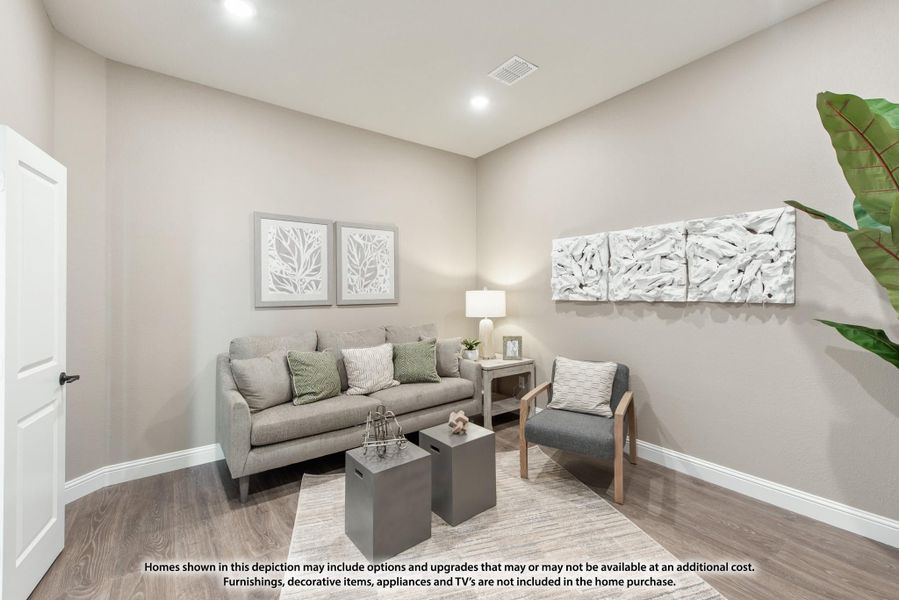 Sitting room with gray sofa, accent chair, hardwood floors, and wall art in neutral tones Sitting room with gray sofa, accent chair, hardwood floors, and wall art in neutral tones