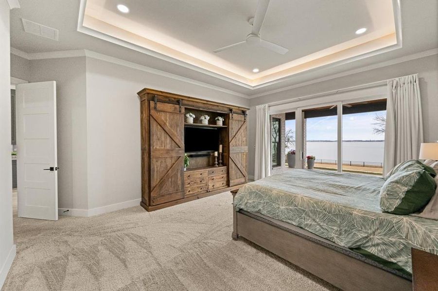 Primary bedroom suite featuring recessed lighting, elegant tray ceiling and a view that motivates and inspires!