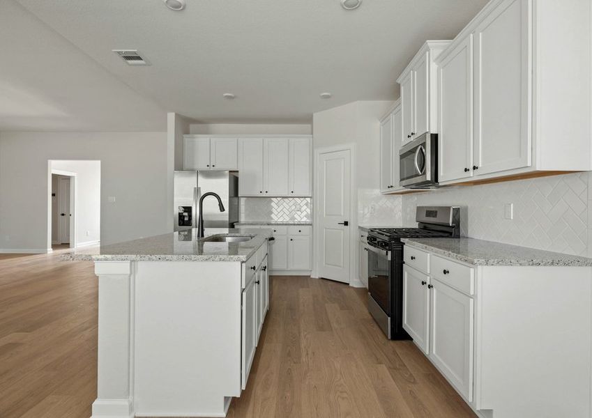 Kitchen with white tile backsplash, white cabinets and granite countertops Kitchen with white tile backsplash, white cabinets and granite countertops
